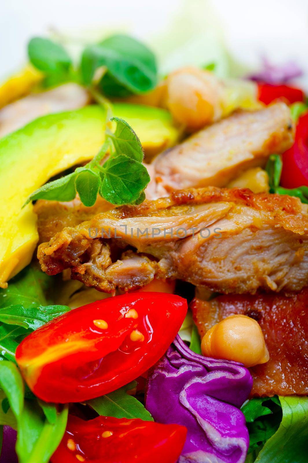 fresh and healthy Chicken Avocado salad over rustic wood table