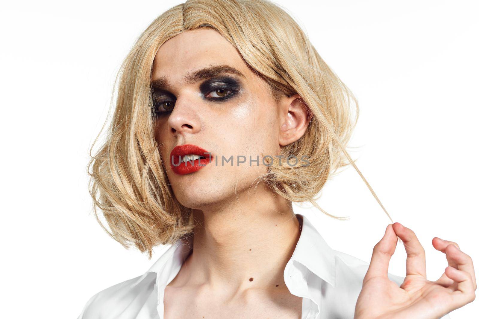 man in women's dress wig makeup posing bisexual. High quality photo