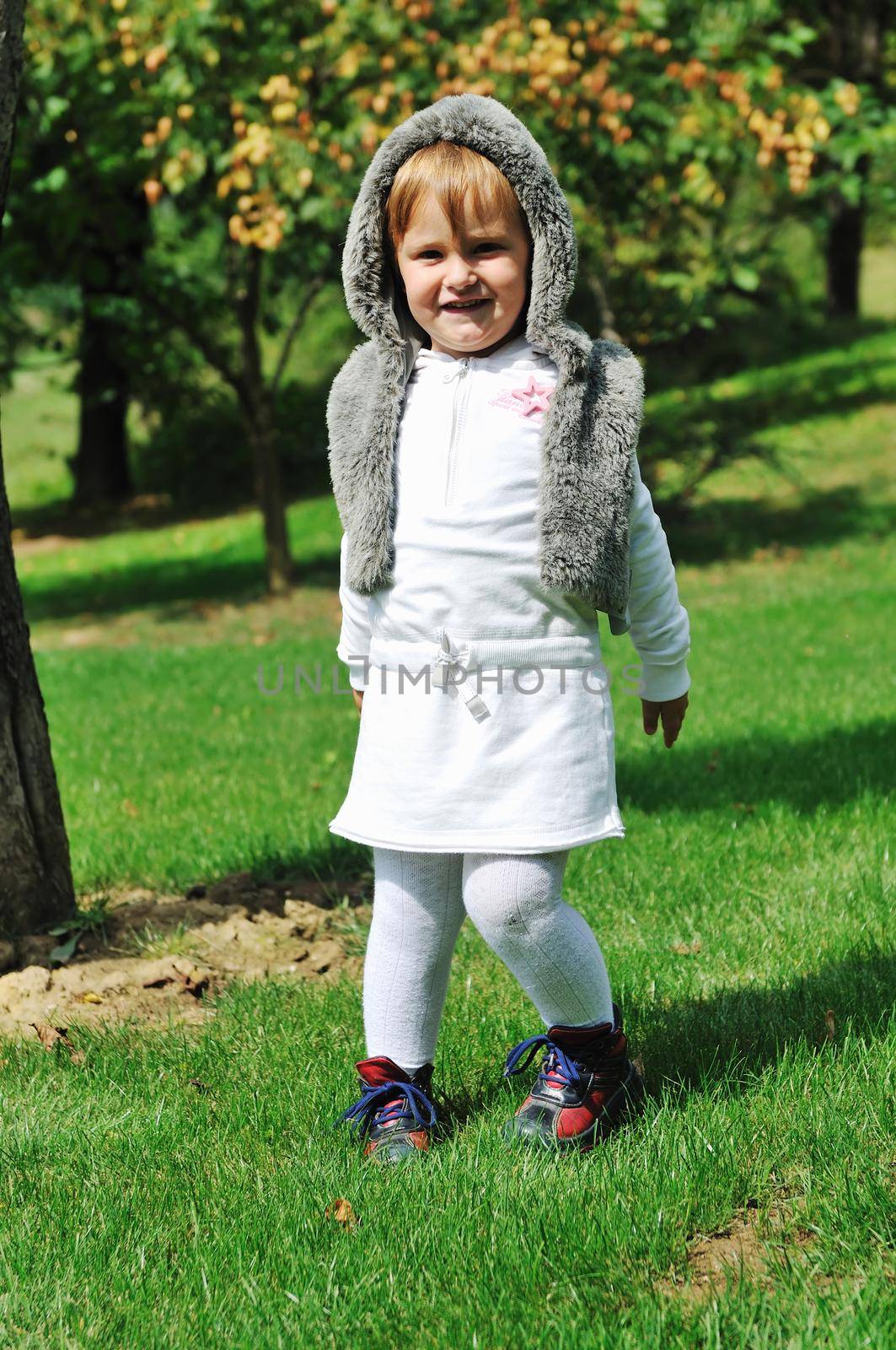 child fashion with beautiful little child outdoor in nature