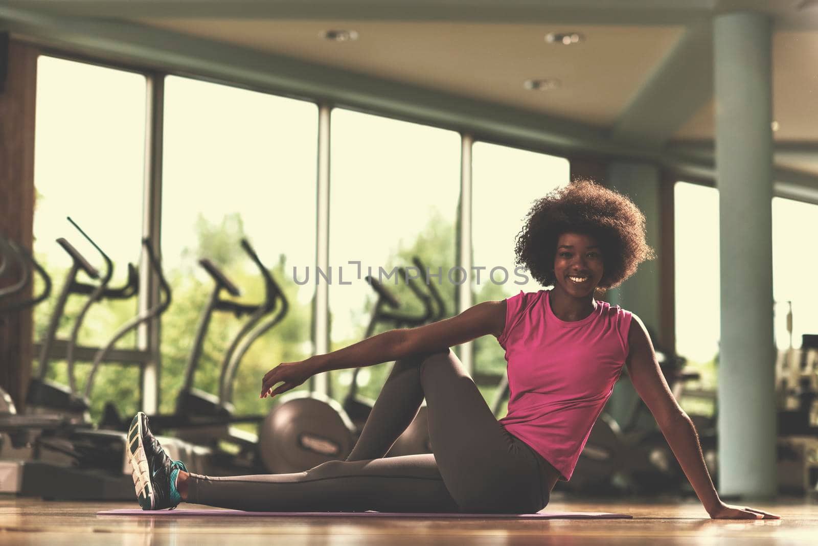 beautiful young african american woman exercise yoga in gym