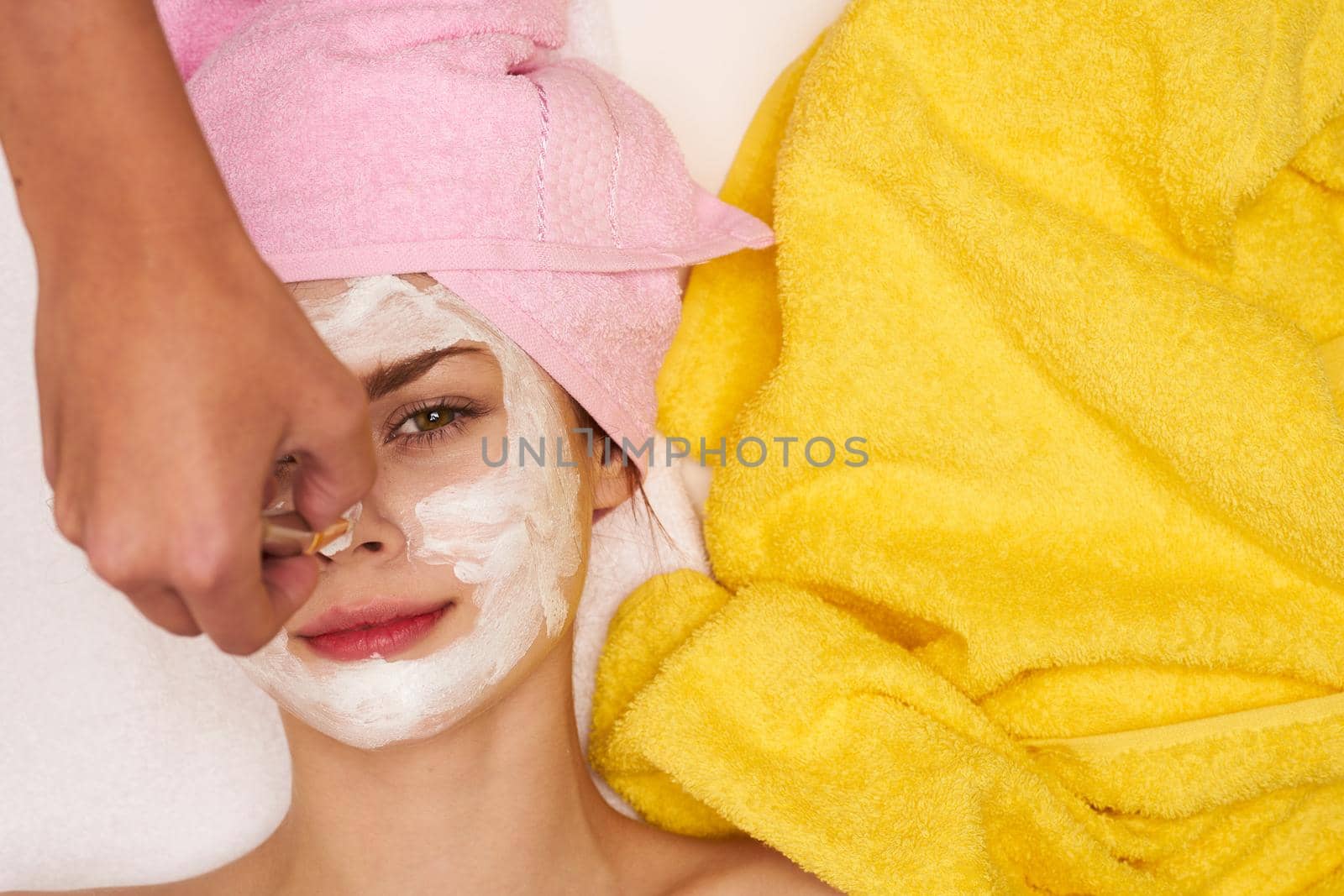 pretty woman with a towel on my head skin care view from above. High quality photo