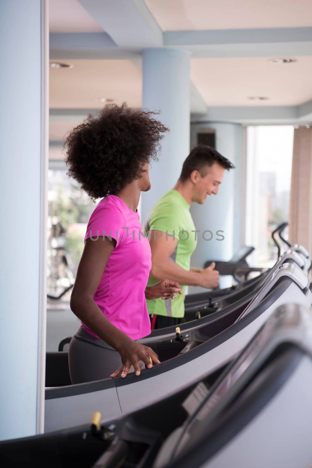 people exercisinng a cardio on treadmill in gym by dotshock