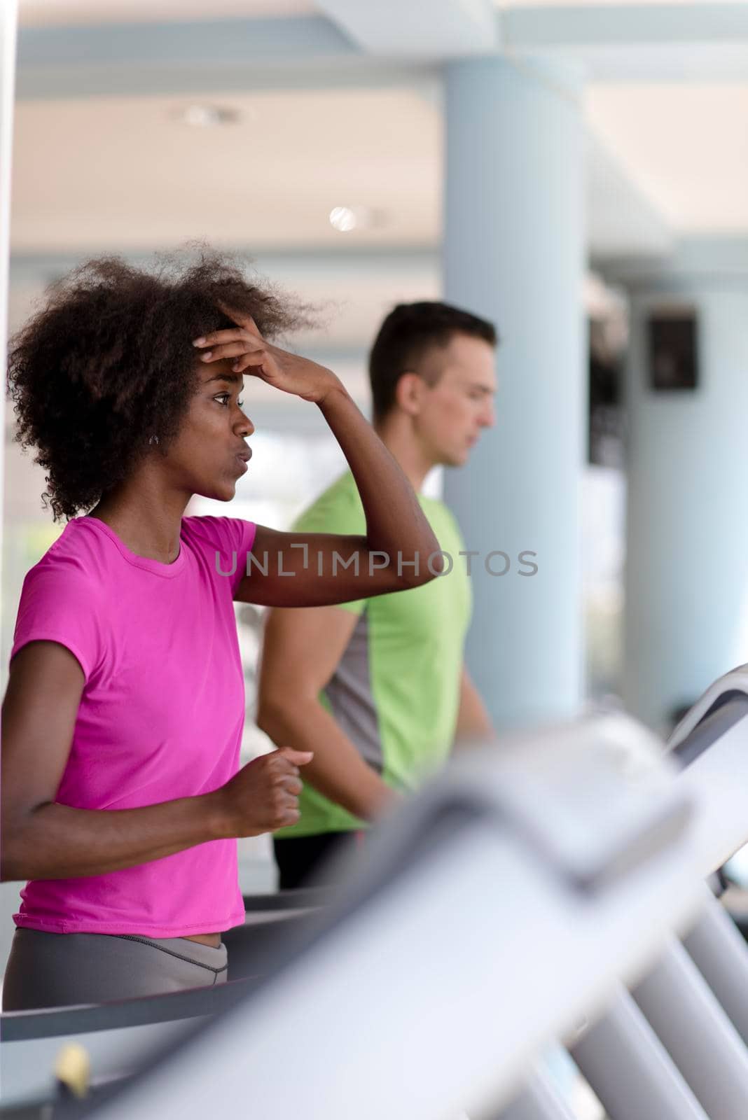 people exercisinng a cardio on treadmill in gym by dotshock