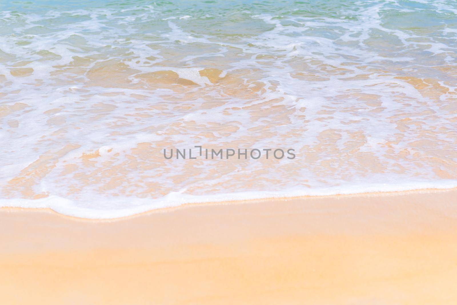 Close up beautiful sea wave on tropical sand beach in summer background by Nuamfolio