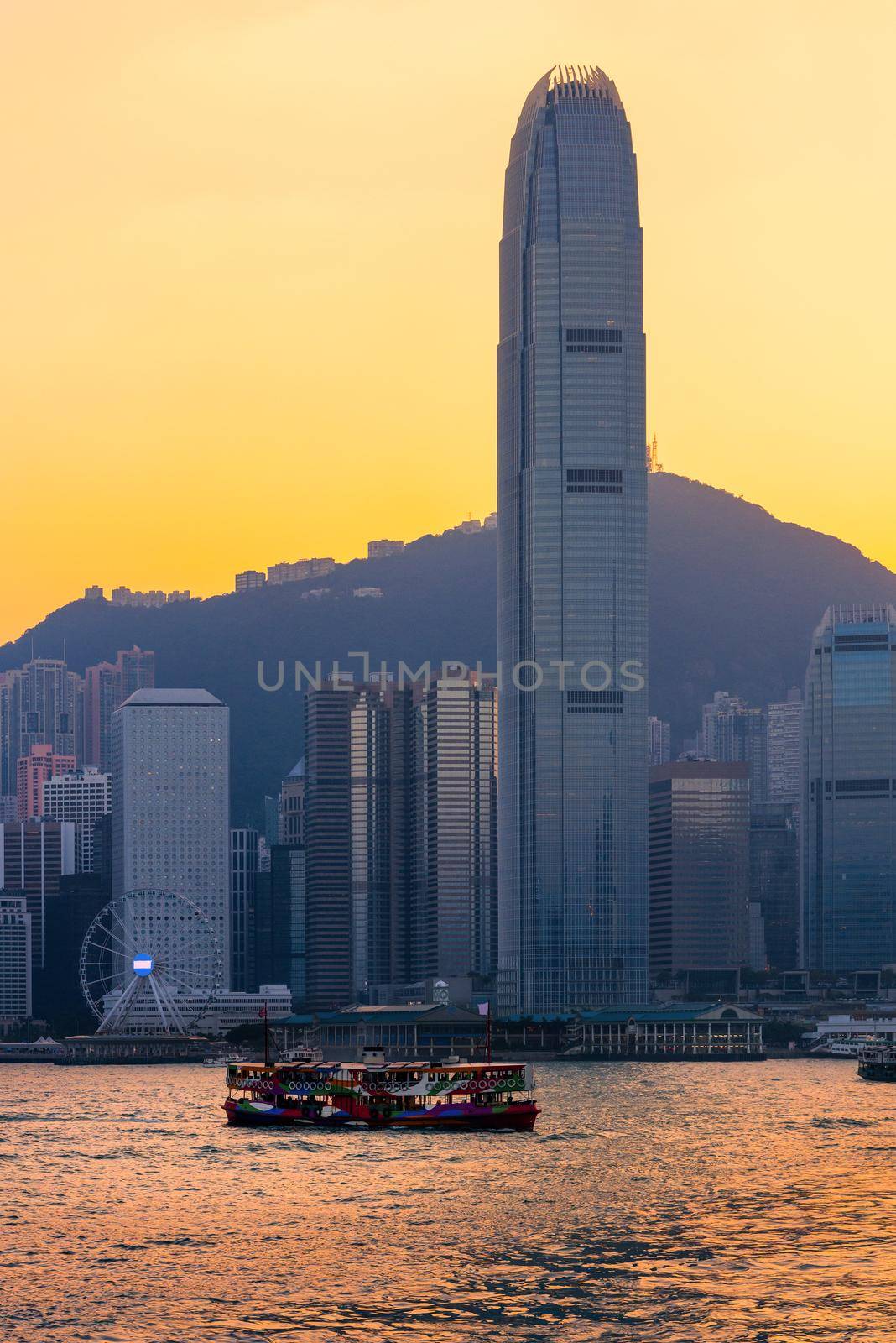 Hong Kong tourists boat for tourist service in victoria harbor with city view in background at sunset view from Kowloon side at Hong Kong