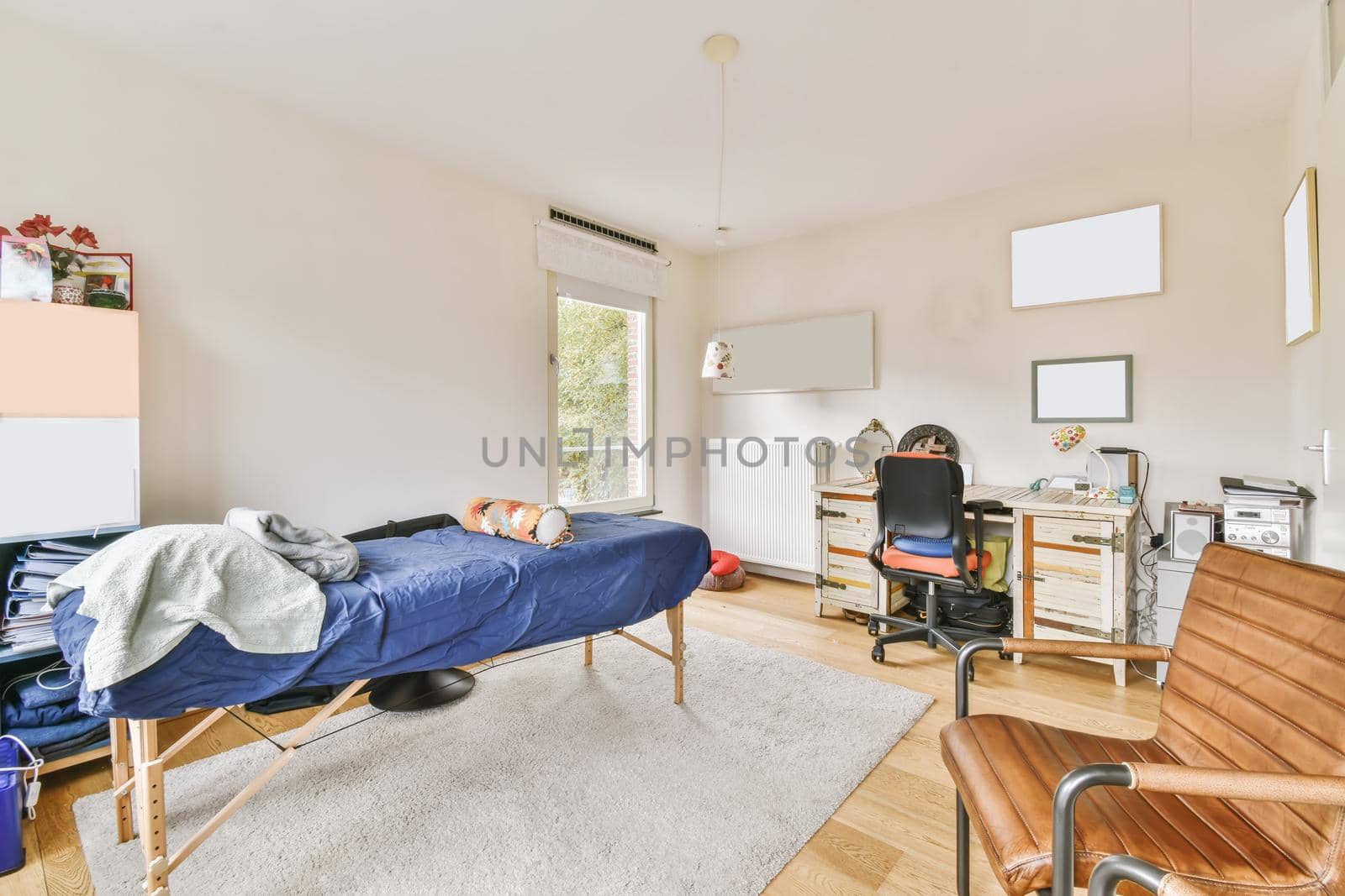 Lovely room with massage table and large windows