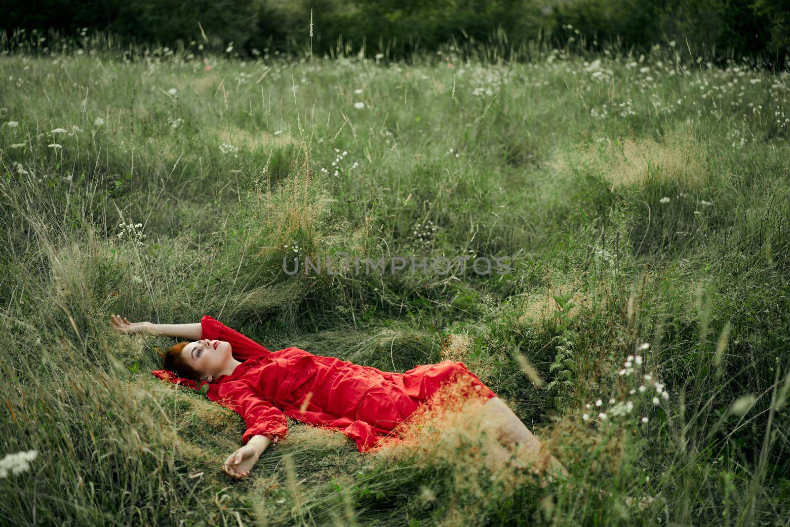 woman in a black dress lies in a field nature fashion summer. High quality photo