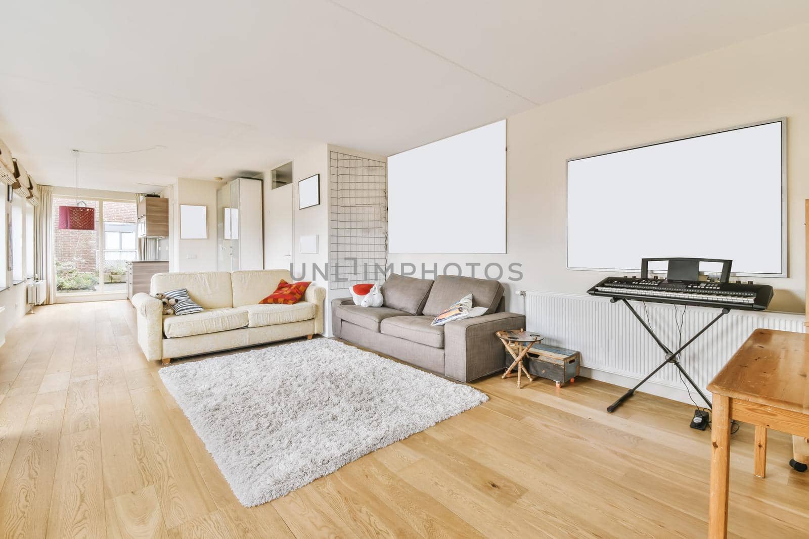 Lovely living room with milky and gray sofas and shaggy carpet