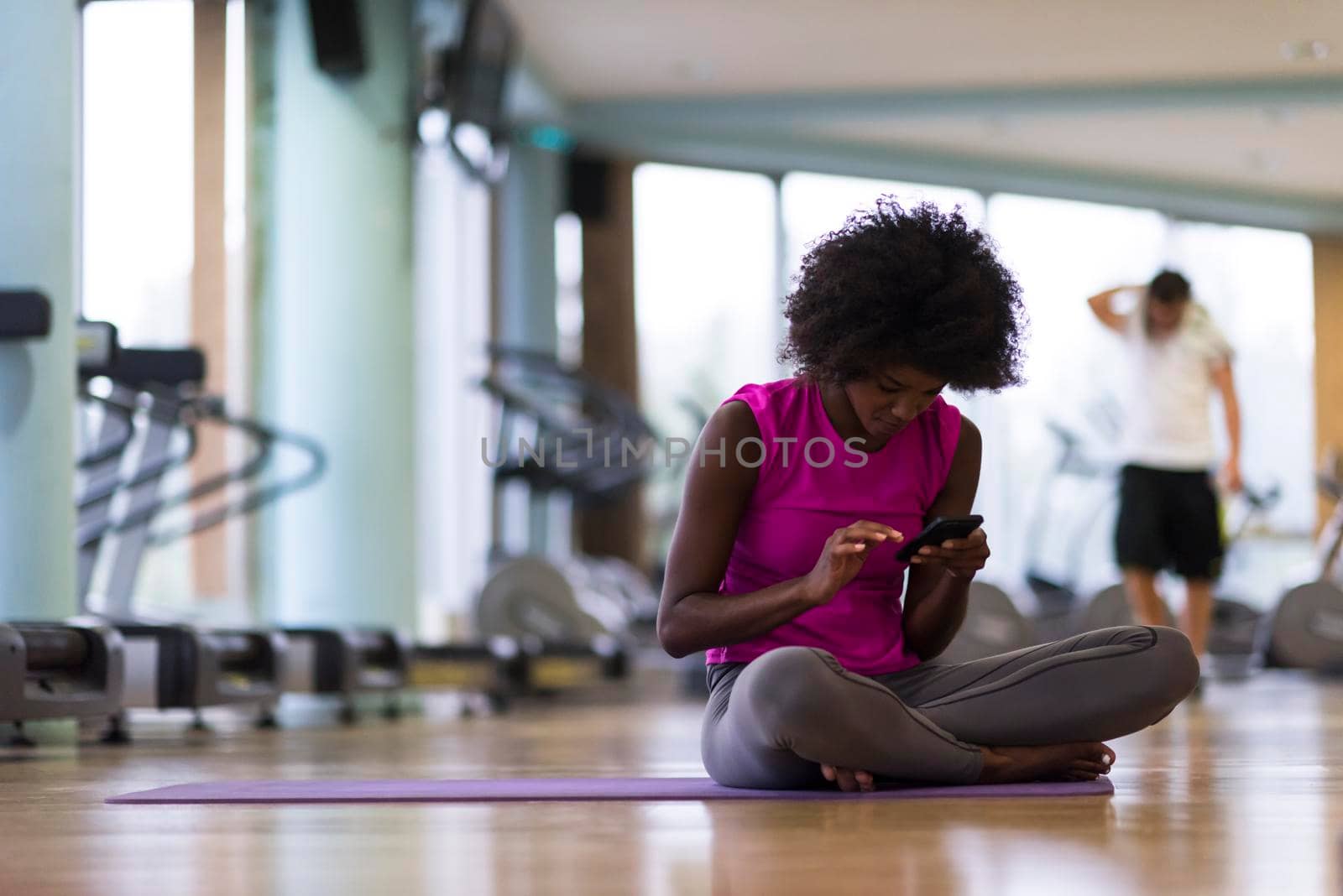african american woman exercise yoga in gym by dotshock