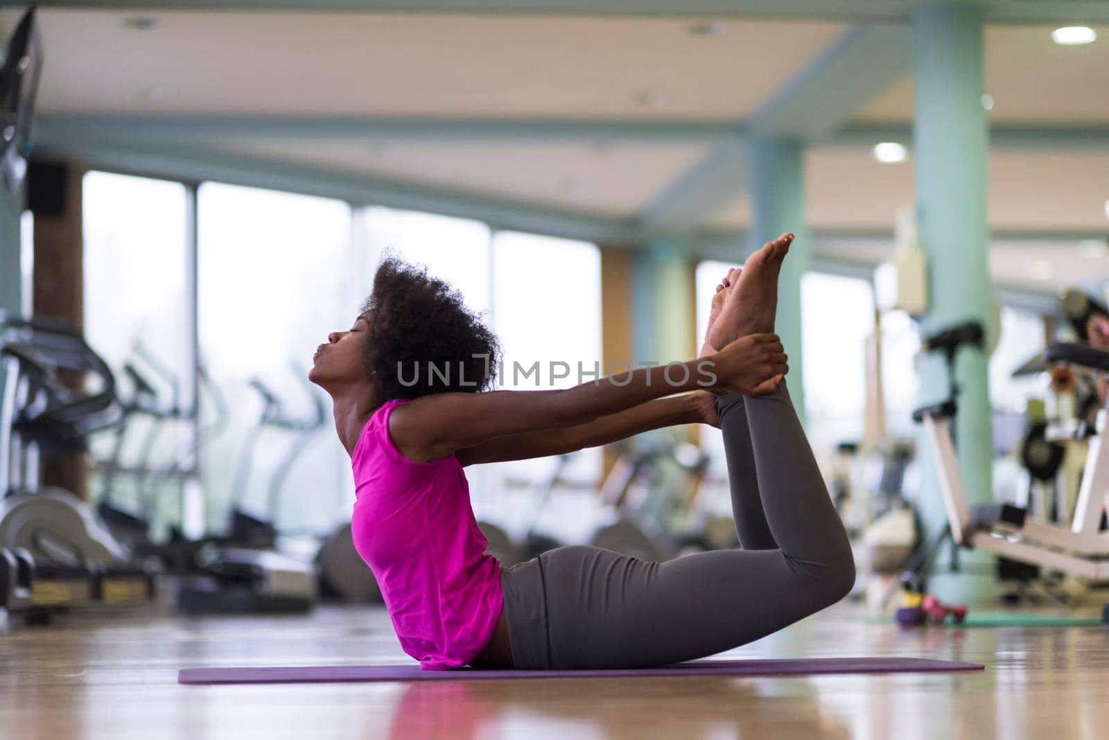 beautiful young african american woman exercise yoga in gym