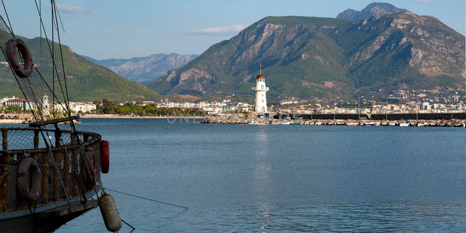 Turkey, Alanya - November 9, 2020: The coastline of Alanya. The old lighthouse in the port of Alanya. View from the sea.