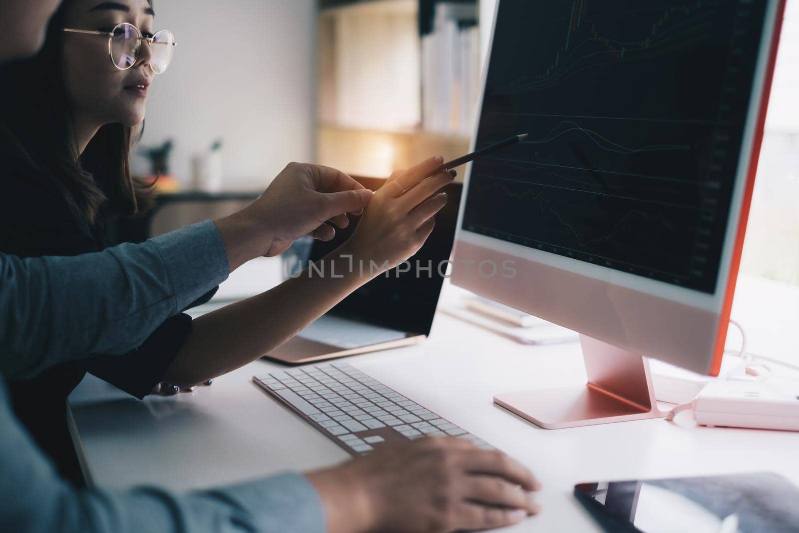 Business team working together and training to analyze technical price graph and indicator. Chart and stock trading computer screen