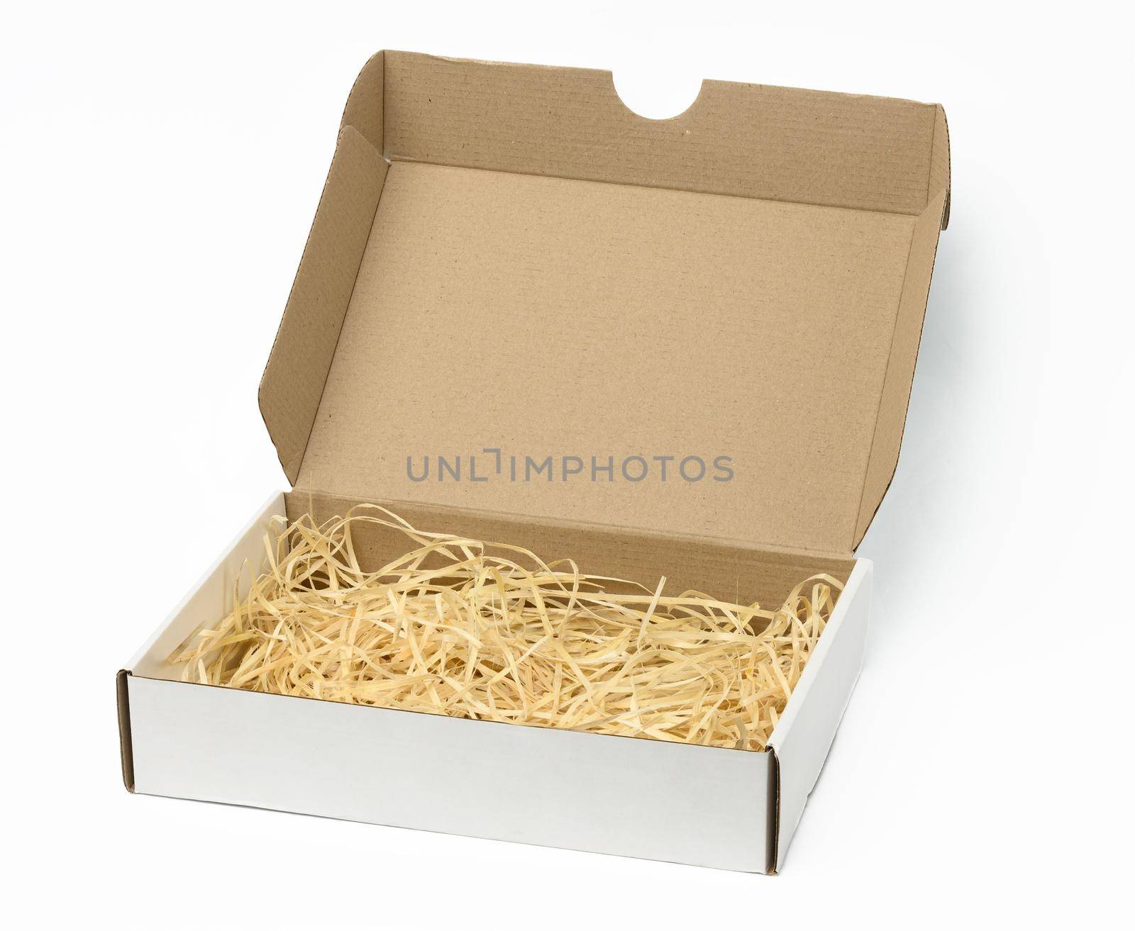 rectangular open corrugated paper box with sawdust inside. Packaging, containers for transportation by ndanko