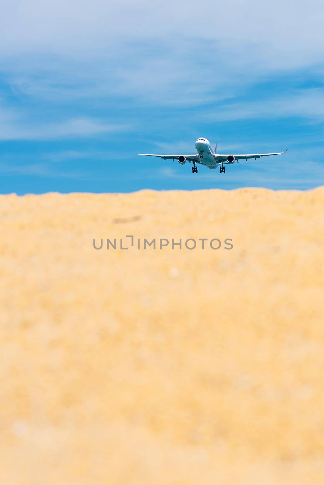 Commercial airplane flying takeoff from international airport with clear sky. by Nuamfolio