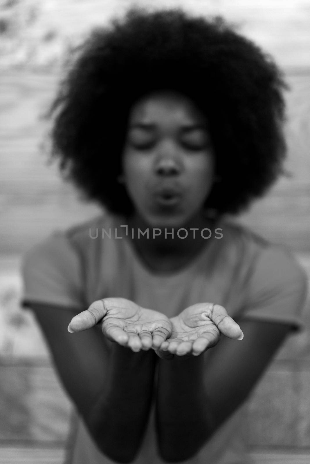 portrait of cute african american woman with afro hairstyle while  posing against old retro wooden background