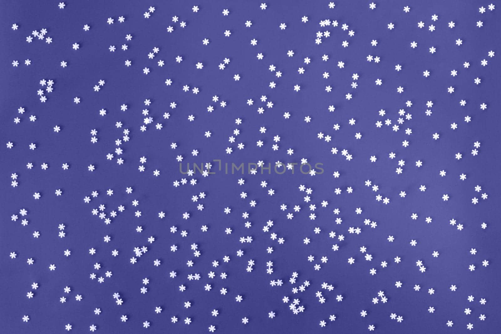 Festive light violet blue background with many snowflakes. Christmas, New Year, Birthday concept. Color of the year 2022. Backdrop for banner or web design. Backplate for happy holidays presentation