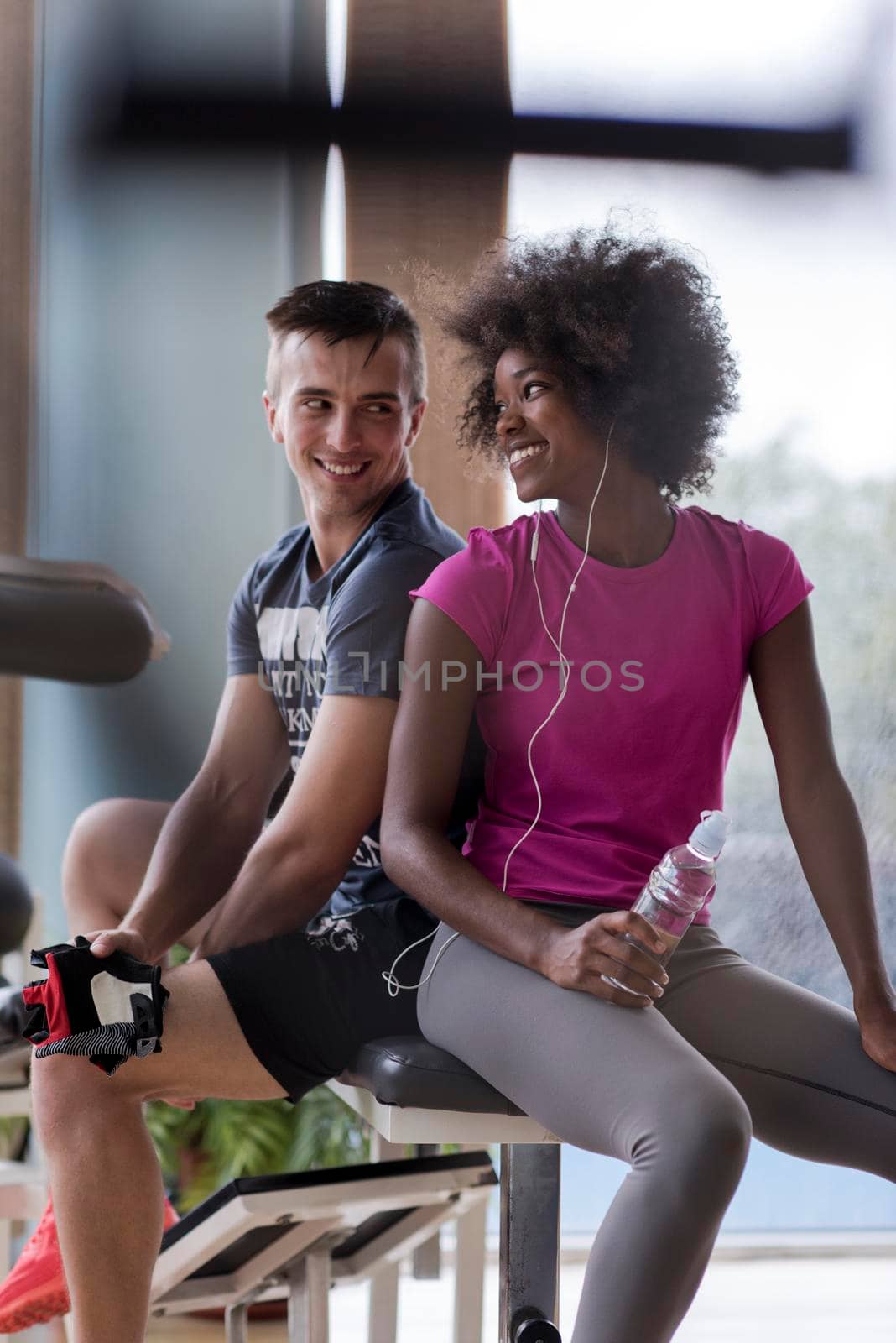 healthy couple have break  at  crossfit gym african  american woman with afro hairstyle