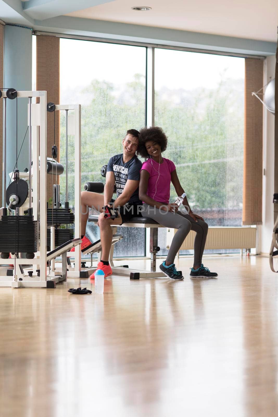 healthy couple have break  at  crossfit gym african  american woman with afro hairstyle