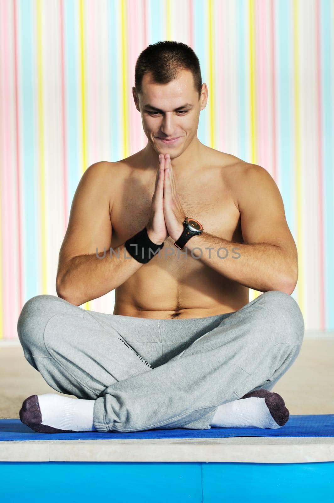 young man exercise and practice yoga fitness  in lotus position indoor in fitness club