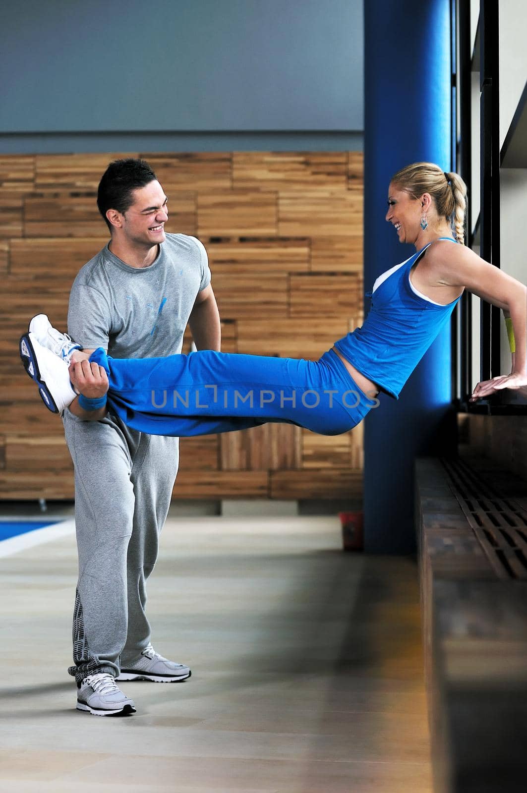 group of young adults exercise in fitness club with trainer