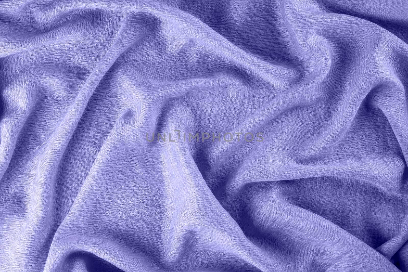 Close-up of lavender purple draped light fabric as background. Color of year 2022. Selective focus.