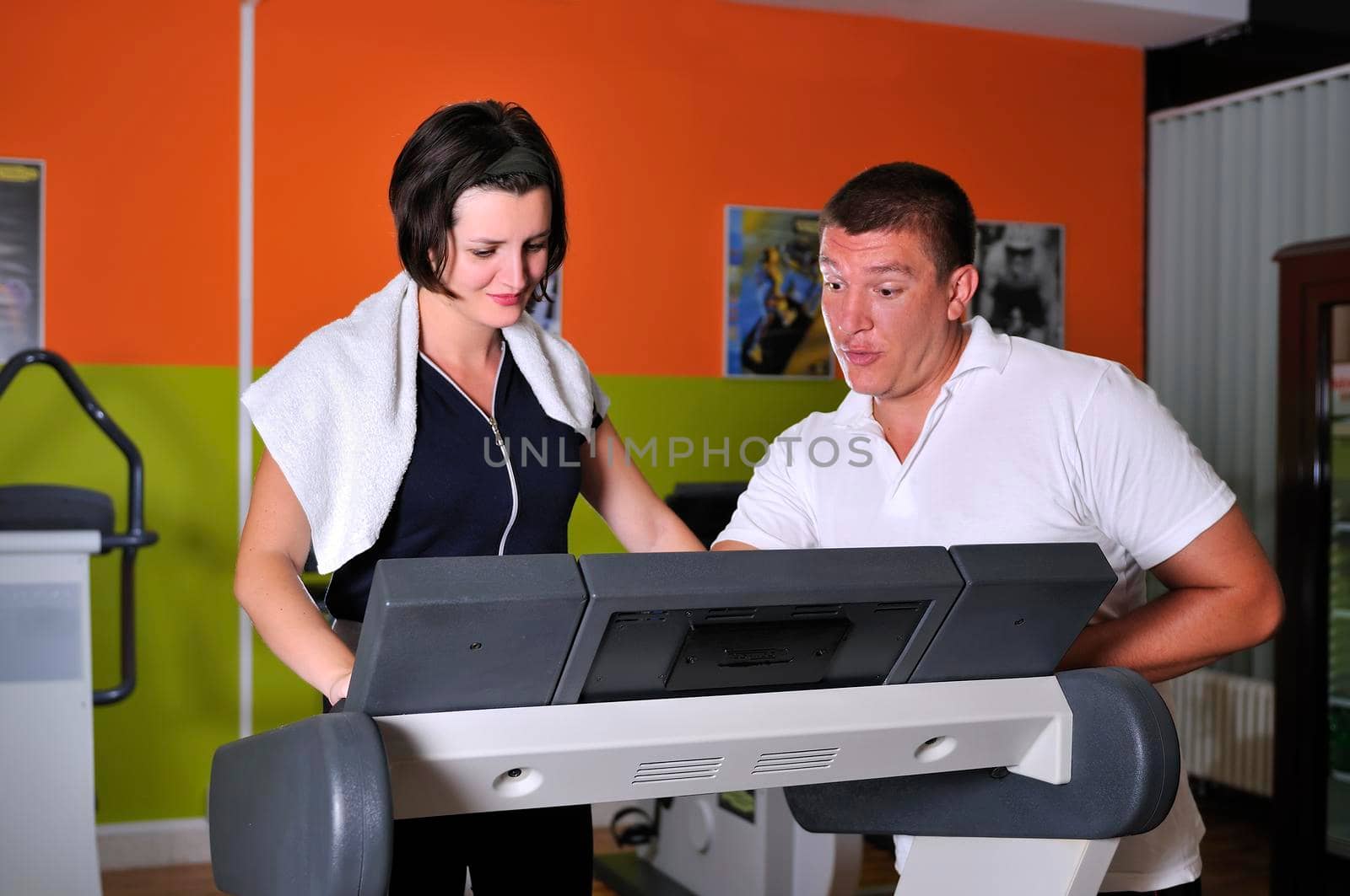 Young woman in gym with coach by dotshock