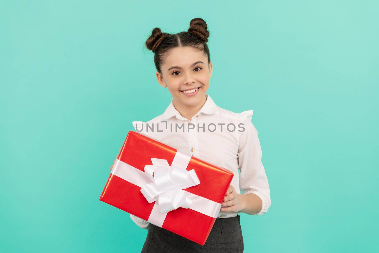 boxing day. present and gifts buy. shopping child with purchase. kid with box. happy birthday holiday. black friday discount. seasonal sales. glad teen girl in school uniform with box.