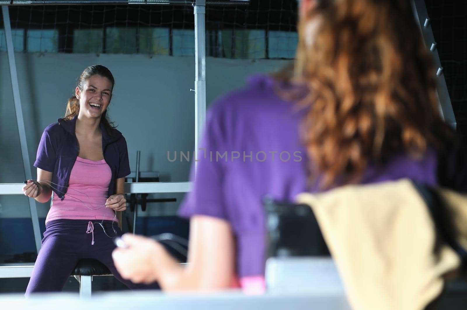 young woman relaxing from working out in a gym  by dotshock