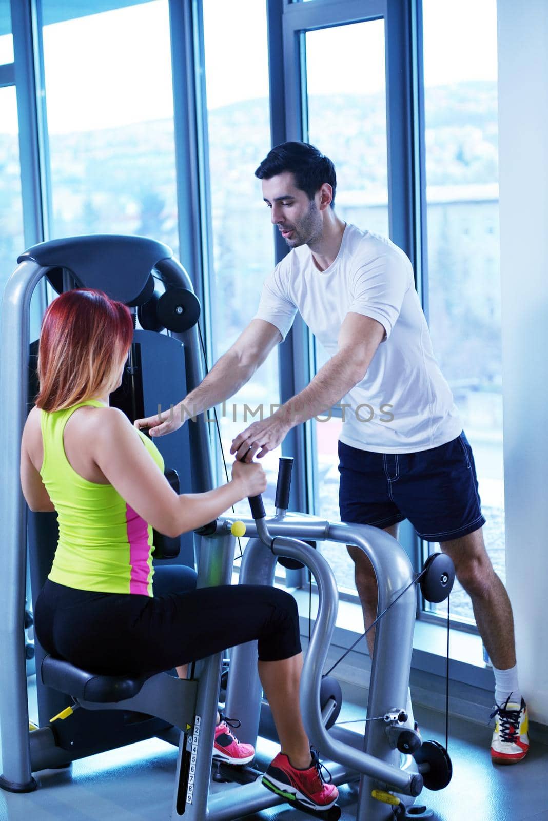 Gym woman exercising with her personal trainer