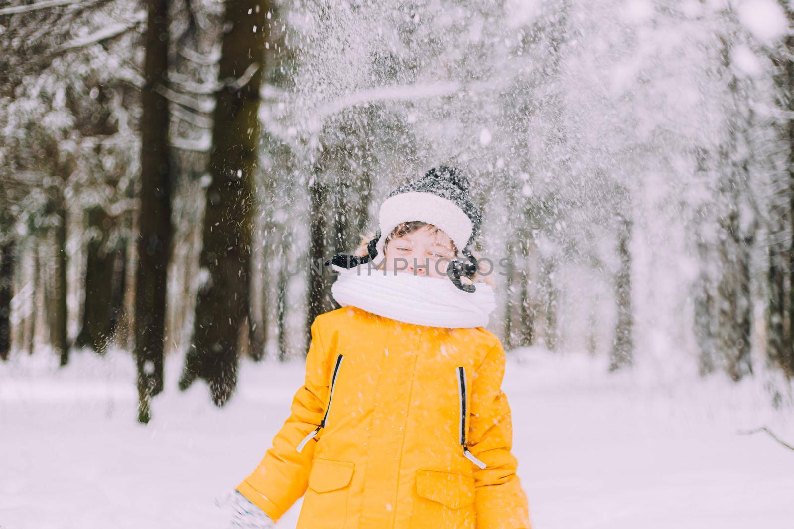 The boy throws snow in winter lifestyle . Winter walks. An article about children's winter leisure. by alenka2194