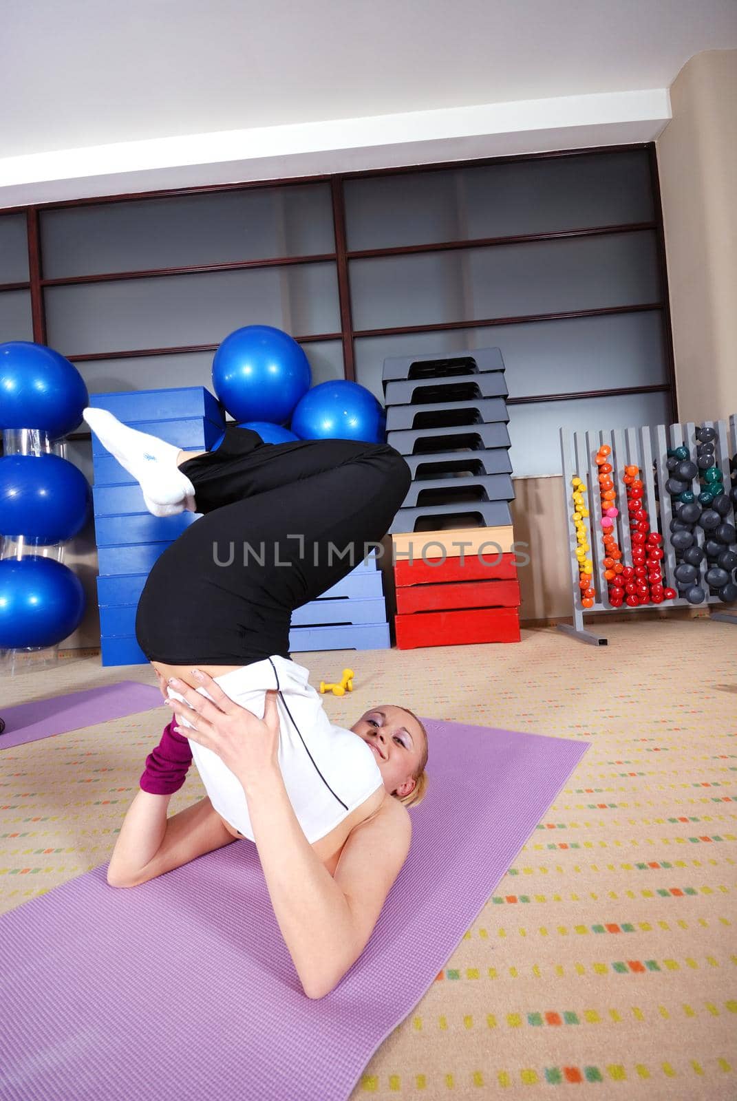 healthy woman exercising in fitness club