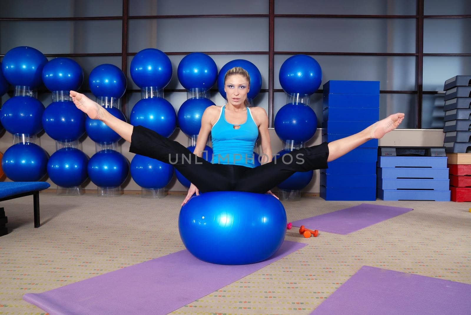health club: women doing stretching and aerobics by dotshock