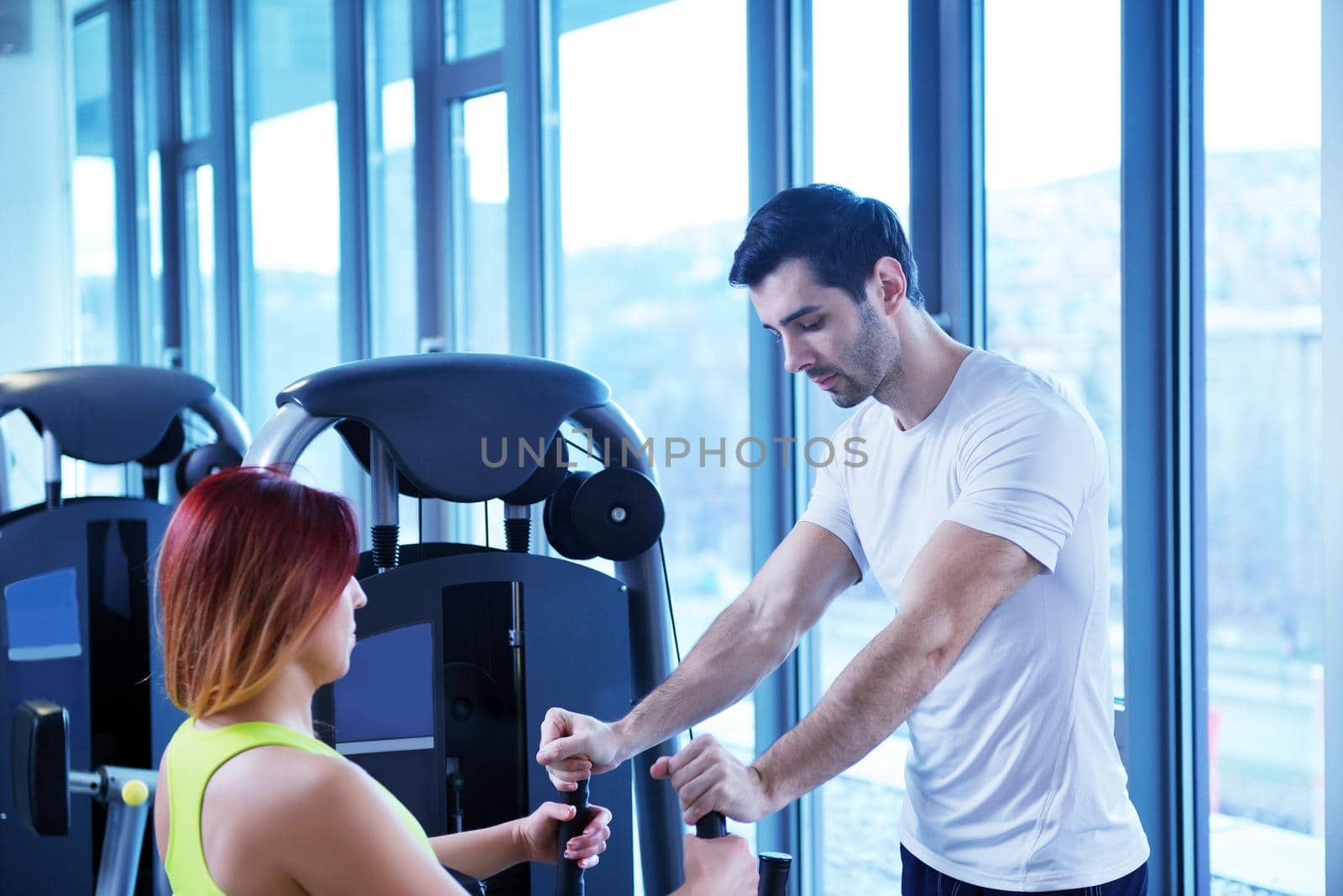 Gym woman exercising with her personal trainer