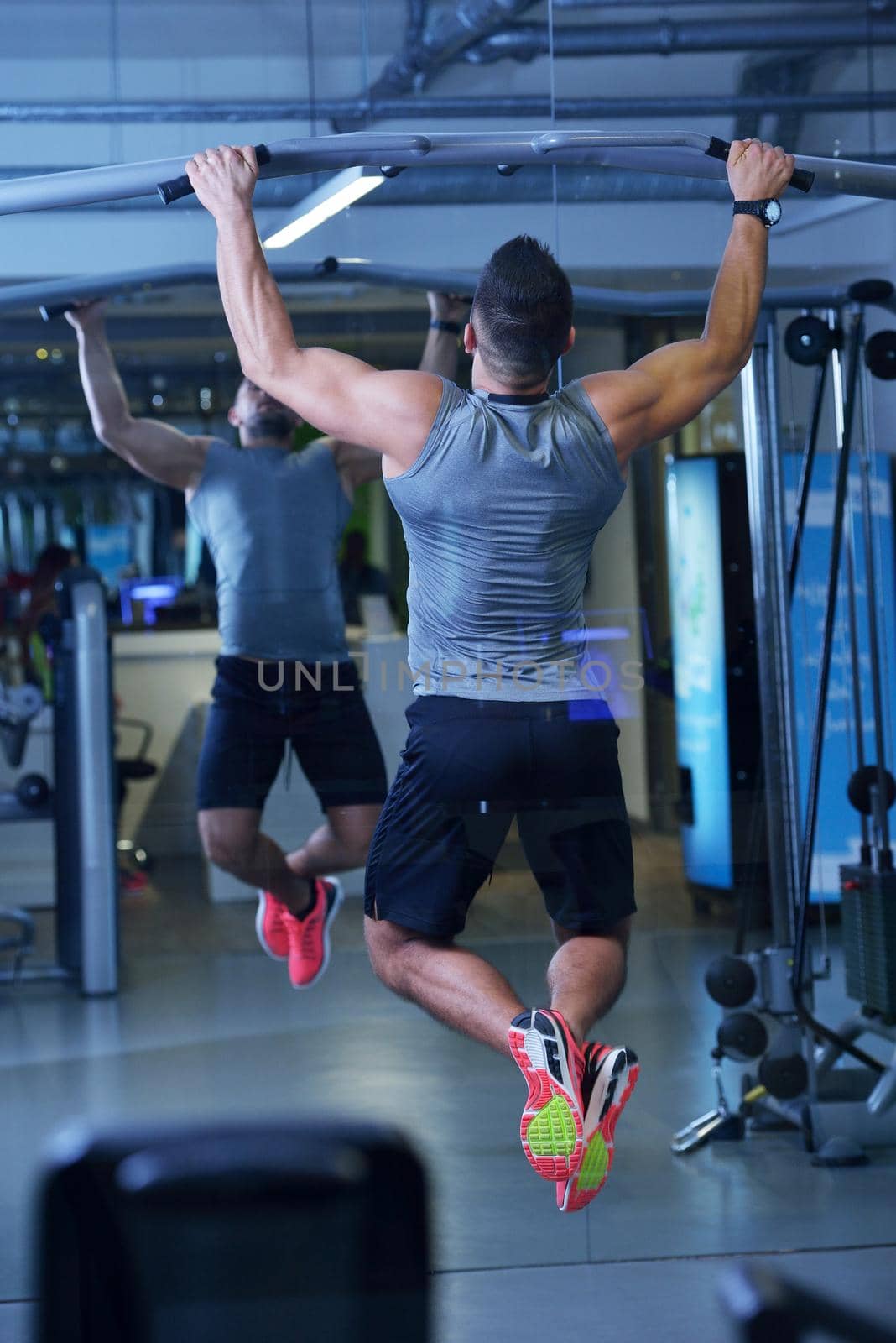 Strong handsome man exercising at the gym