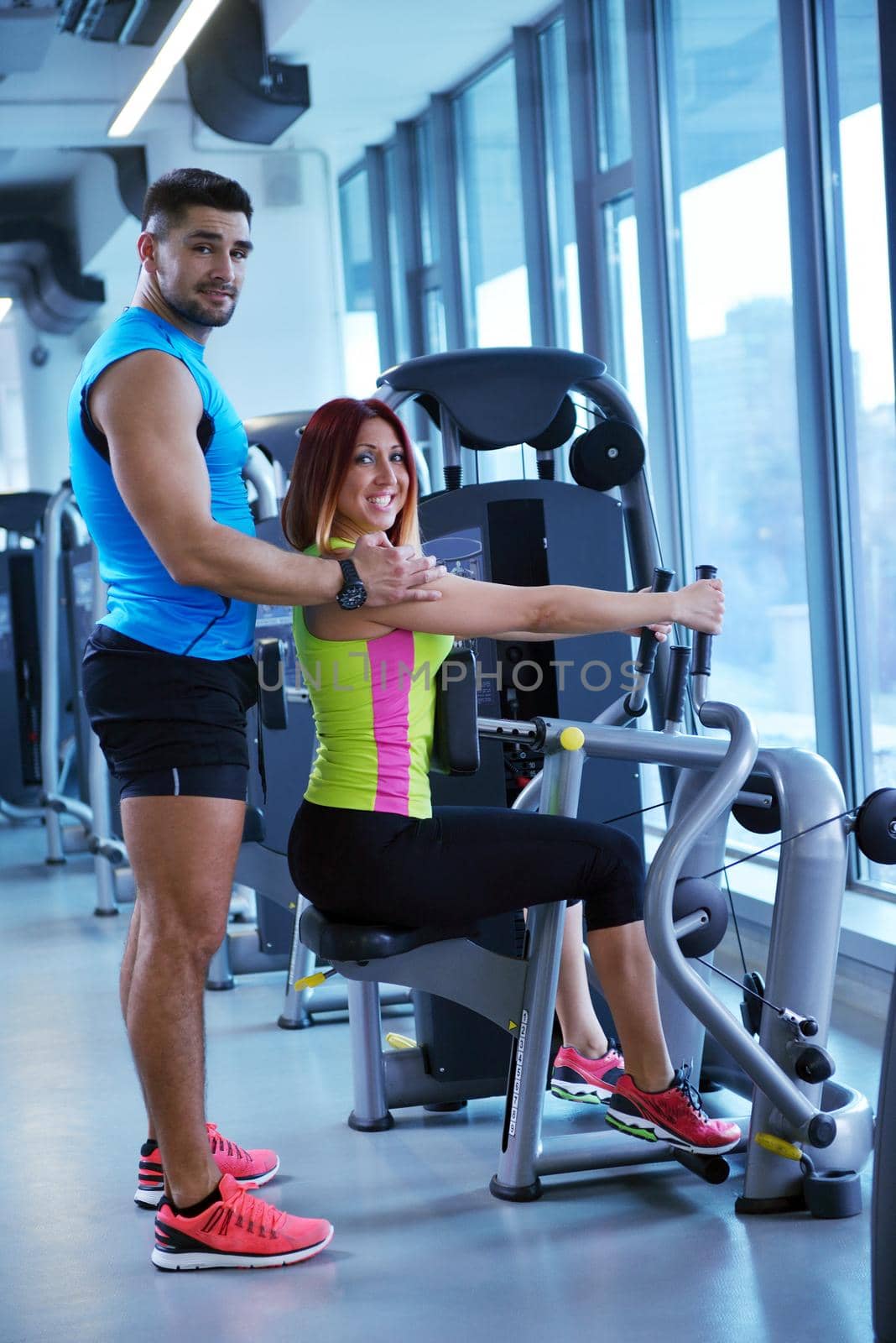 Gym woman exercising with her personal trainer