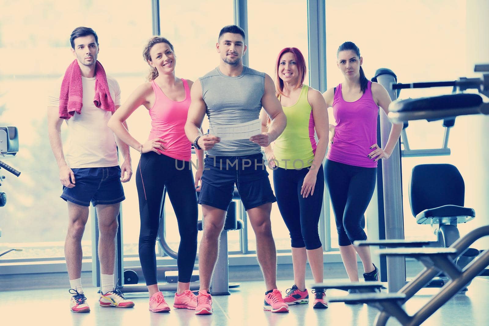 Group of people exercising at the gym and stretching