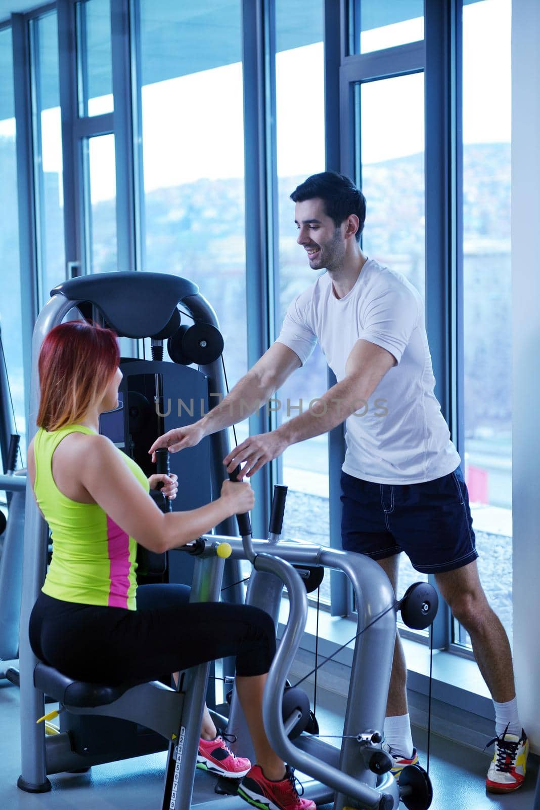 Gym woman exercising with her personal trainer