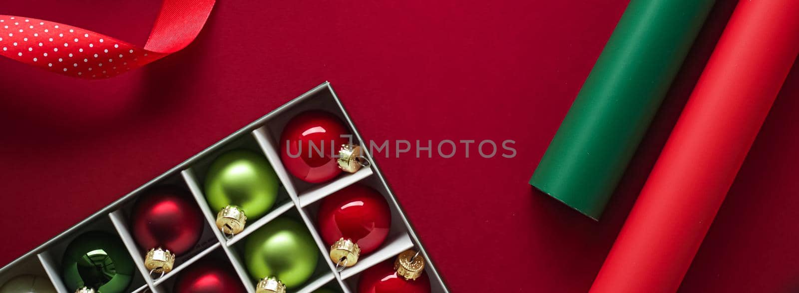 Christmas flatlay and holiday design concept. Decoration, ornament and xmas gift wrapping on red paper background as flat lay top view.