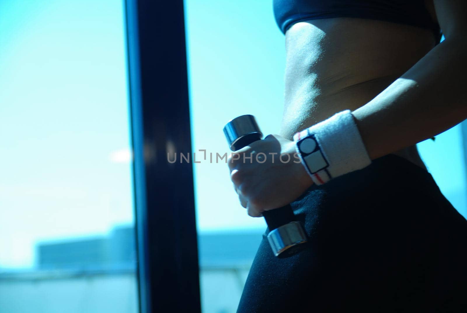 woman doing exercise with dumbbell