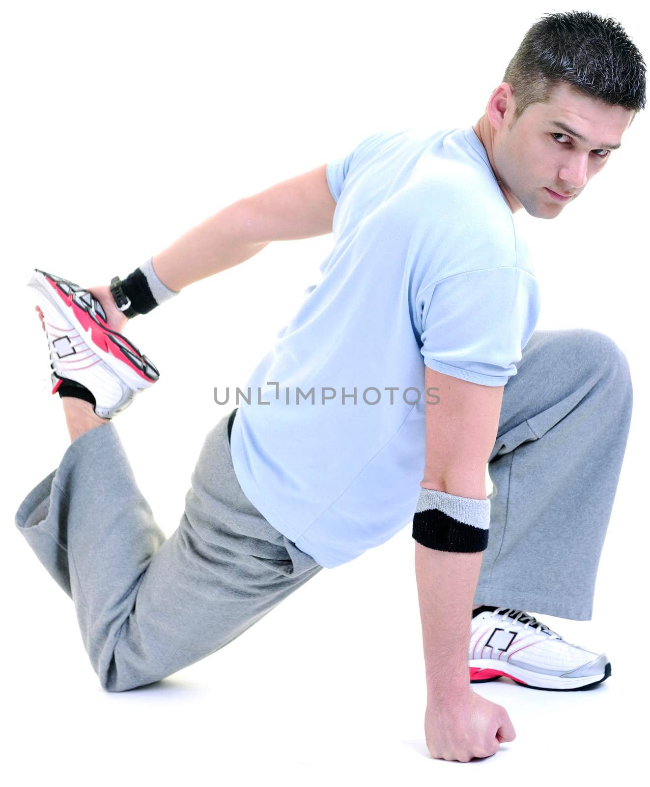 young man exercise fitness sport and strech isolated on white in studio