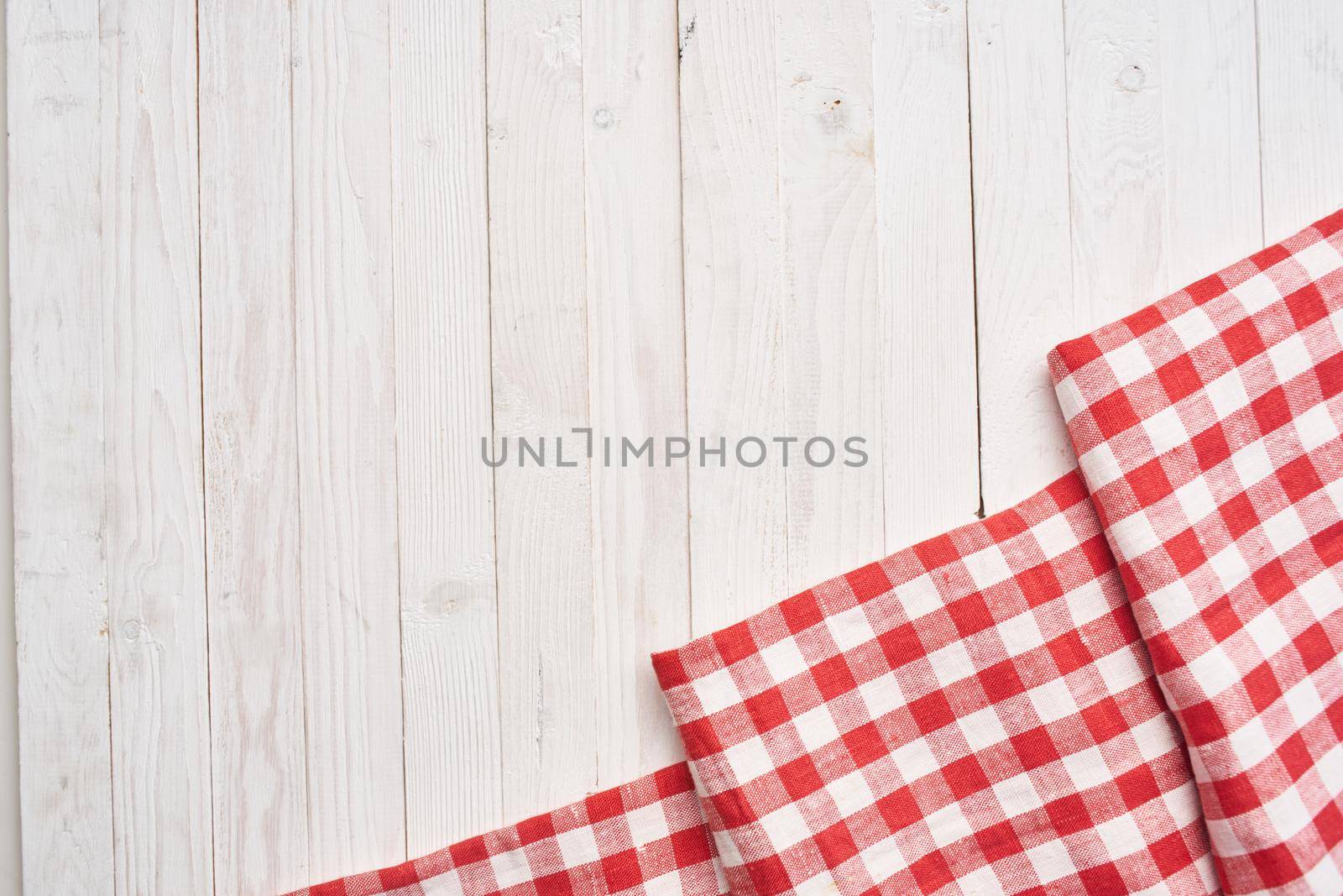 Red checkered tablecloth wooden background texture kitchen decoration. High quality photo