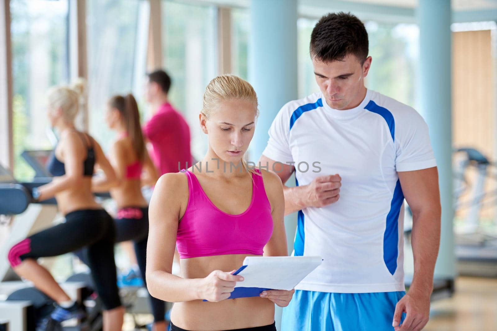 group portrait of healthy and fit young people in fitness gym