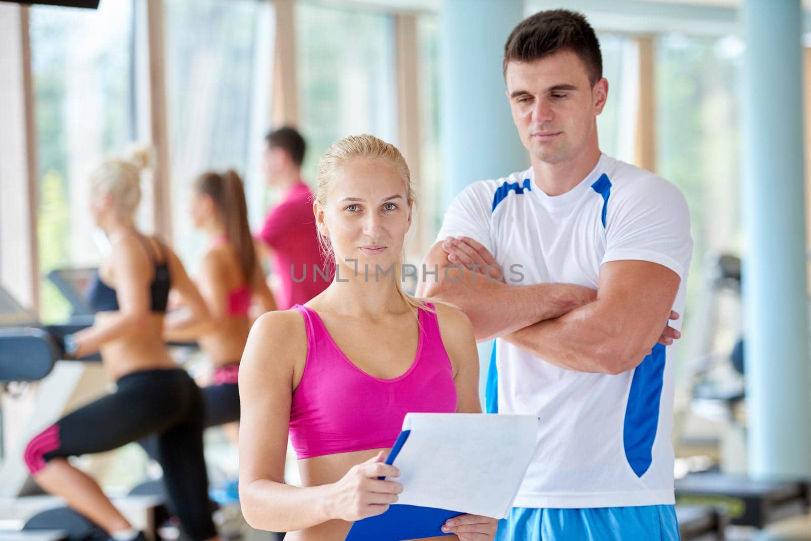 group portrait of healthy and fit young people in fitness gym