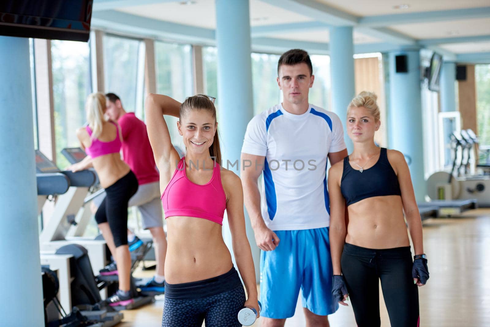 group portrait of healthy and fit young people in fitness gym