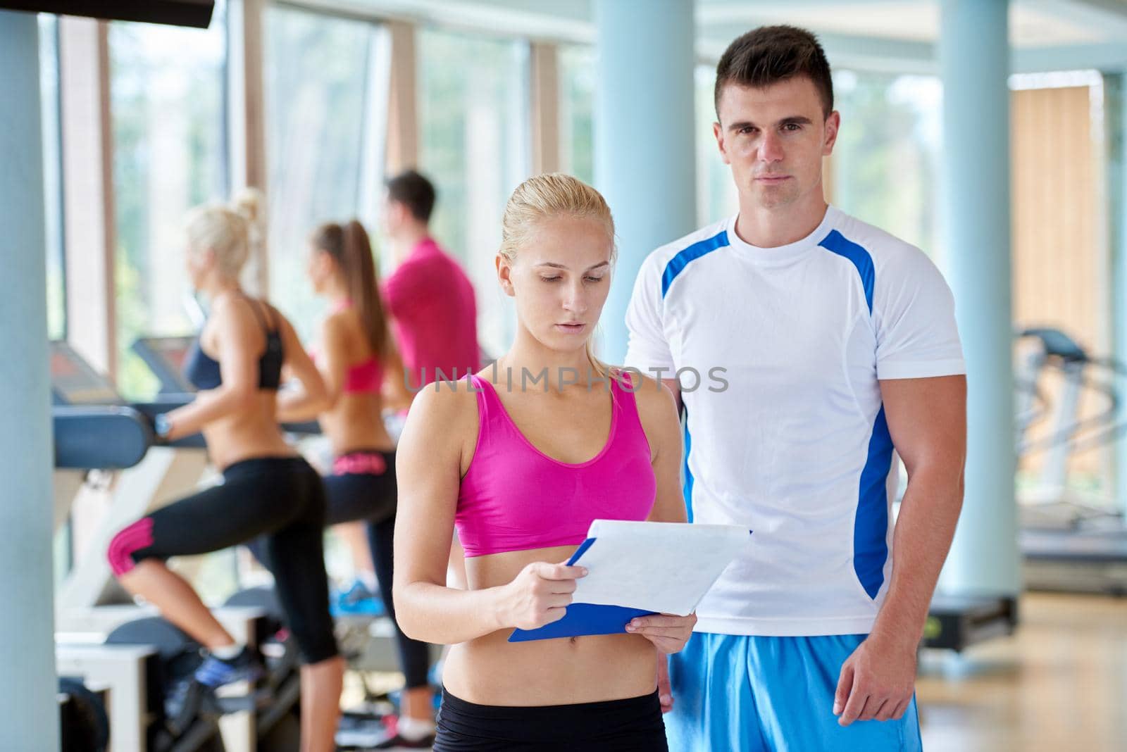 group portrait of healthy and fit young people in fitness gym