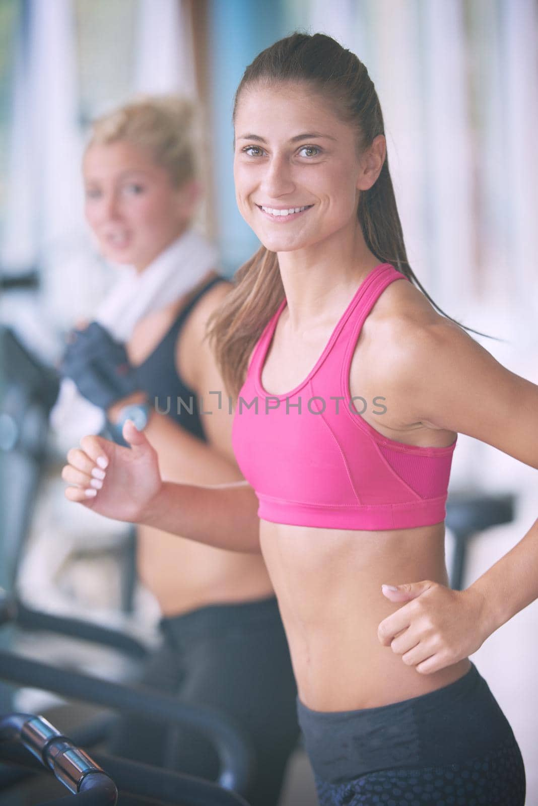 sport, fitness, lifestyle, technology and people concept - smiling woman exercising on treadmill in gym