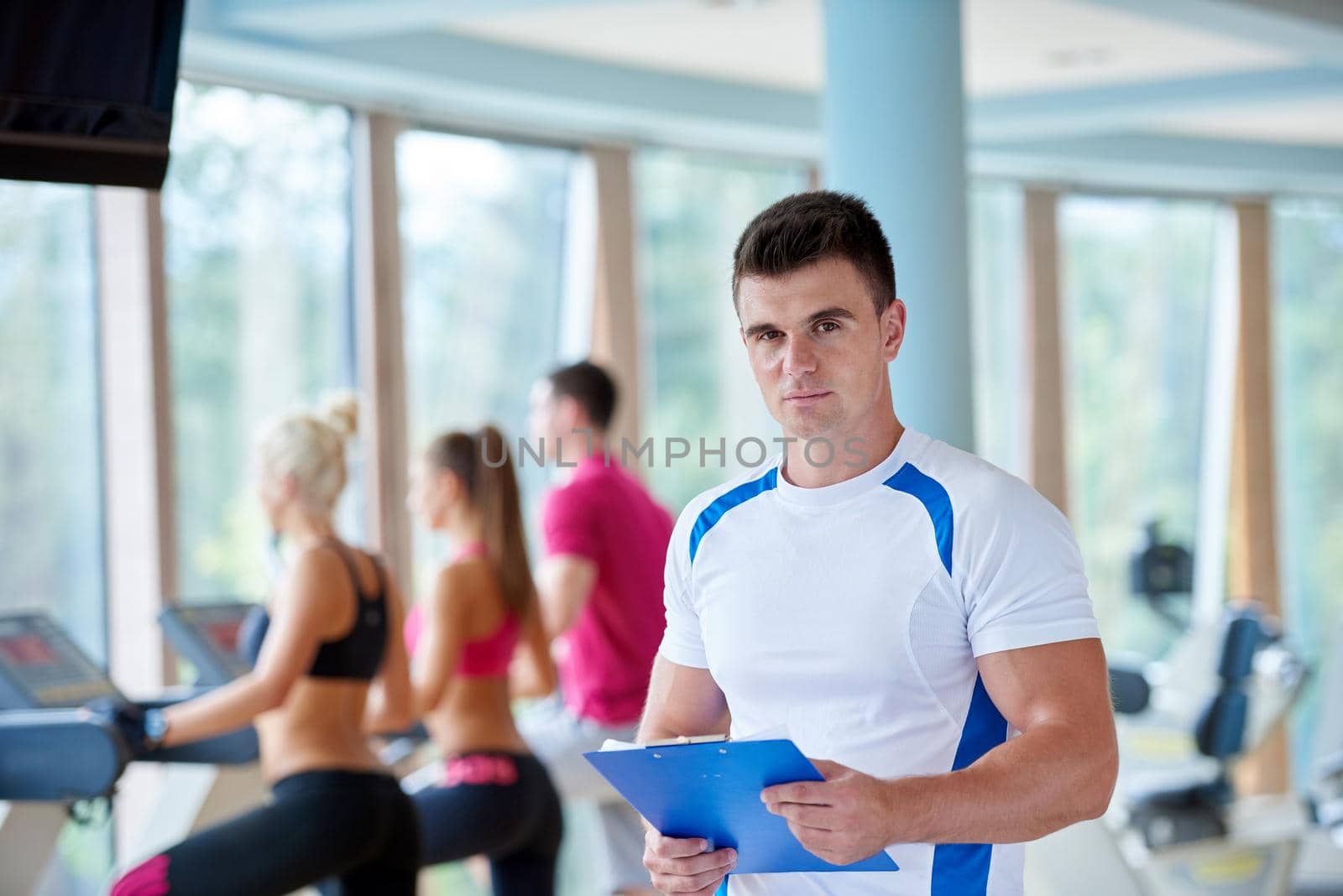 group portrait of healthy and fit young people in fitness gym