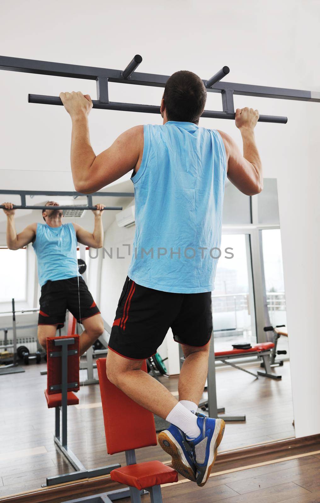 young man in fintess sport club exercise withweights and relaxing