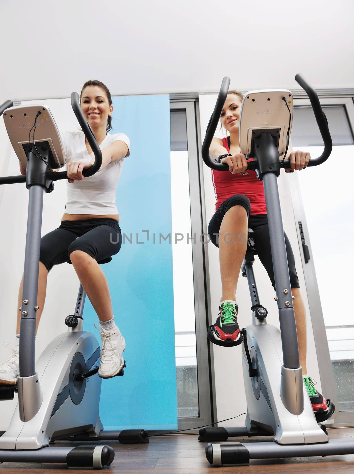 young woman exercise fitness and workout while run on track in sport club