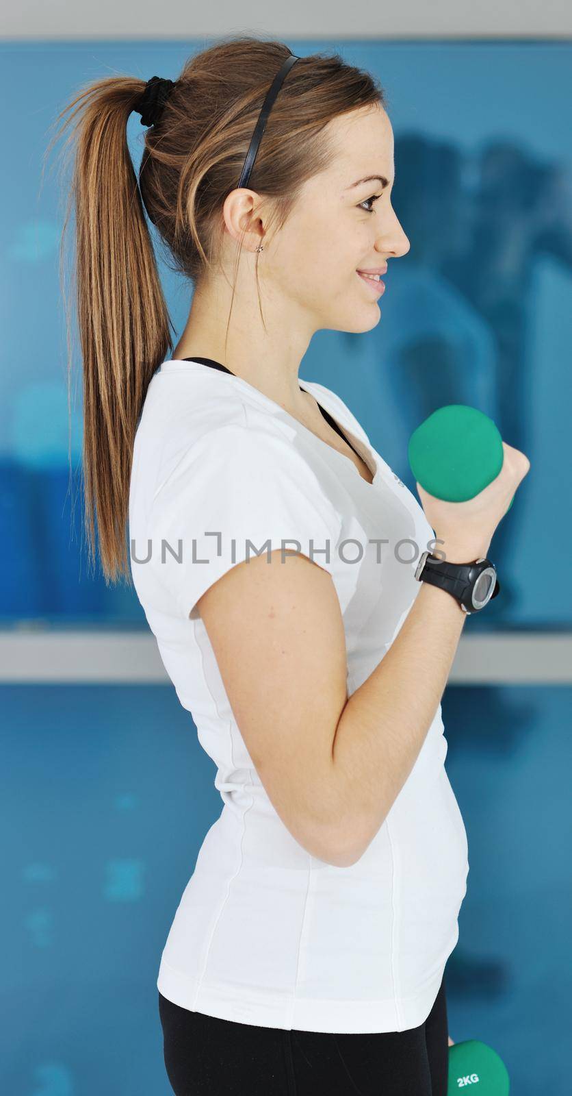 beaudiful young woman fitness workout with weights at sport club